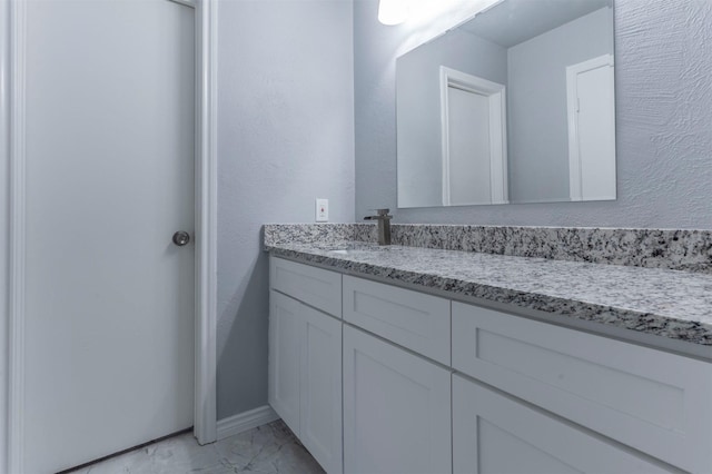 8721 N Normandale St, Fort Worth, TX 76116 - bathroom with vanity, marble look tiles, and baseboards