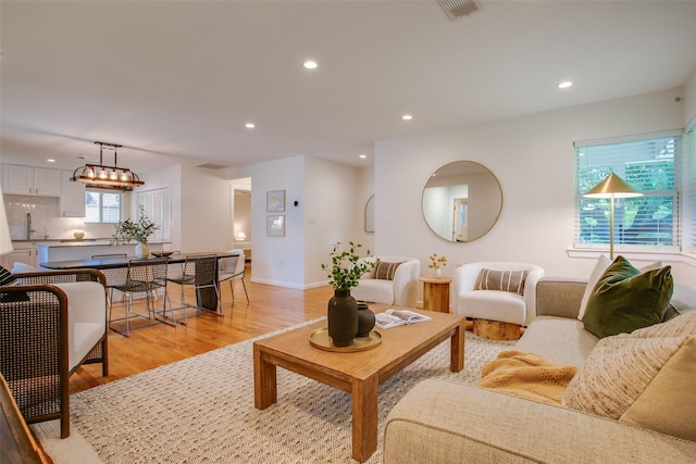 1205 Ranier St, Dallas, TX 75208 - living room with light wood-type flooring, recessed lighting, and baseboards