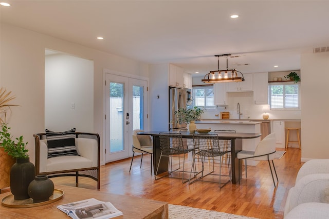 1205 Ranier St, Dallas, TX 75208 - dining room with light wood-style flooring and recessed lighting