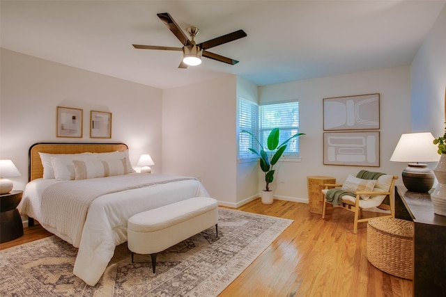 1205 Ranier St, Dallas, TX 75208 - bedroom with light wood finished floors, baseboards, and a ceiling fan
