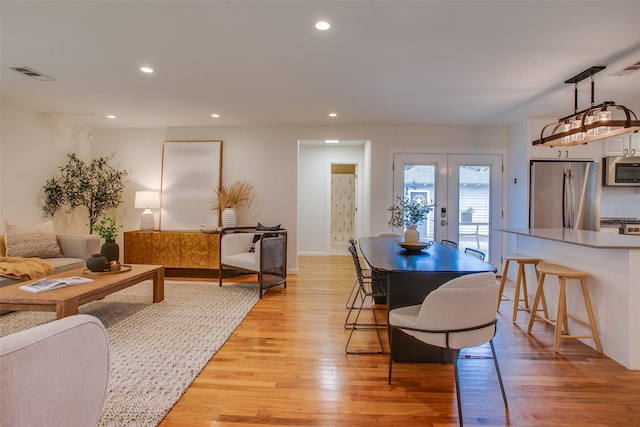 1205 Ranier St, Dallas, TX 75208 - dining room with french doors, recessed lighting, light wood finished floors, and baseboards
