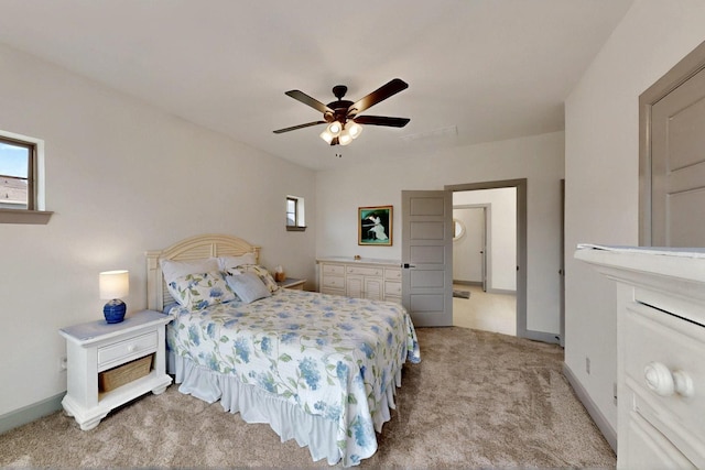 carpeted bedroom with multiple windows, baseboards, and ceiling fan