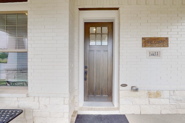 property entrance with brick siding