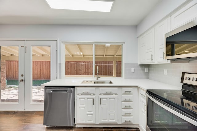 3243 Weather Vane Ln, Dallas, TX 75228 - kitchen featuring appliances with stainless steel finishes, a sink, decorative backsplash, and white cabinets