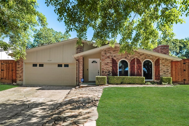 3243 Weather Vane Ln, Dallas, TX 75228 - view of front of property featuring an attached garage, brick siding, concrete driveway, a chimney, and a gate