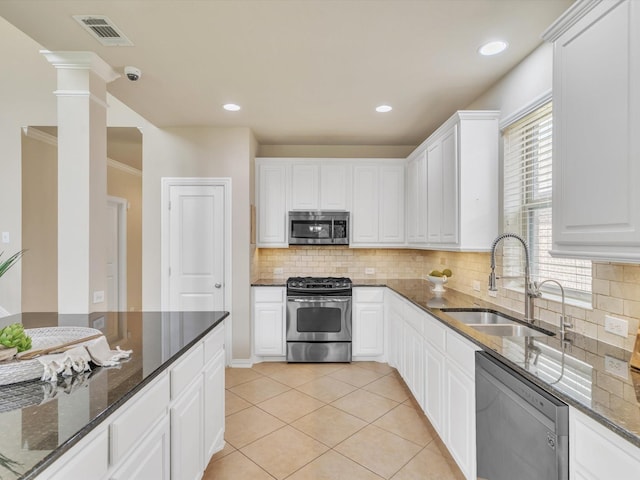 8400 Whistling Duck, Fort Worth, TX 76118 - kitchen with stainless steel appliances, a sink, dark stone counters, white cabinetry, and tasteful backsplash