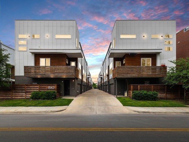 1510 N Washington Ave Unit 503, Dallas, TX 75204 - view of front of home with board and batten siding, a balcony, and fence