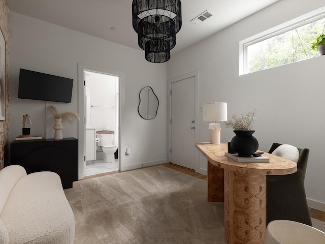 1510 N Washington Ave Unit 503, Dallas, TX 75204 - bedroom with baseboards, light colored carpet, and ensuite bath