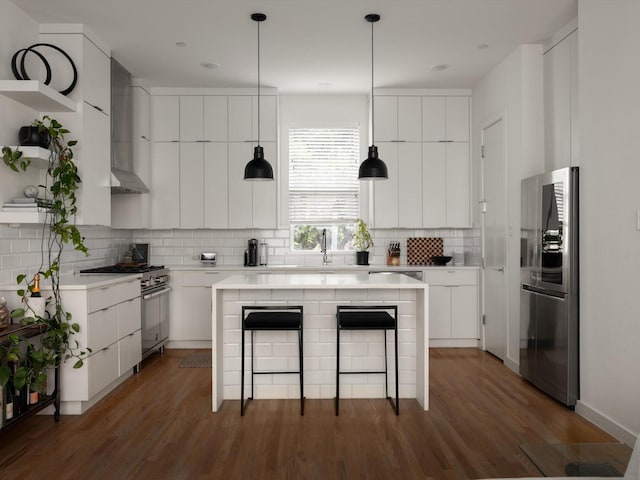1510 N Washington Ave Unit 503, Dallas, TX 75204 - kitchen featuring appliances with stainless steel finishes, open shelves, a kitchen bar, decorative backsplash, and light countertops