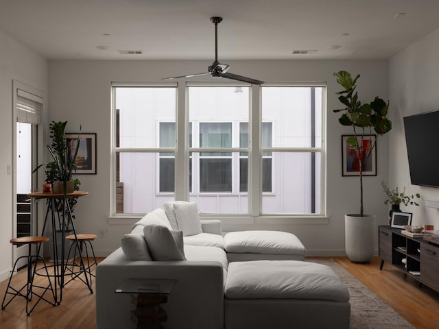 1510 N Washington Ave Unit 503, Dallas, TX 75204 - living area with a ceiling fan, wood finished floors, and baseboards