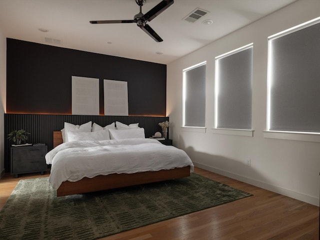 1510 N Washington Ave Unit 503, Dallas, TX 75204 - bedroom with baseboards, wood finished floors, and a ceiling fan