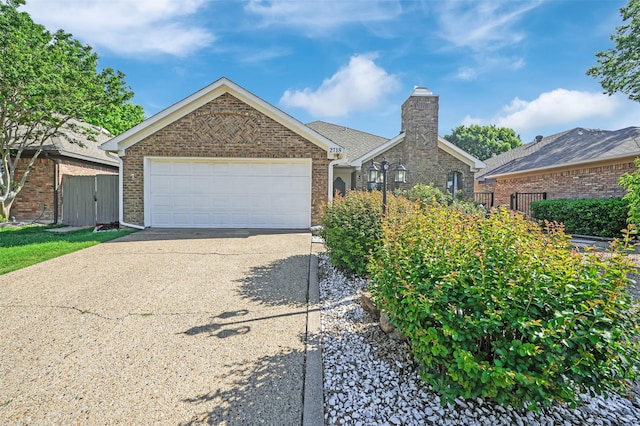 2718 Laurel Oaks Dr, Garland, TX 75044 - ranch-style house with driveway, brick siding, a chimney, and an attached garage