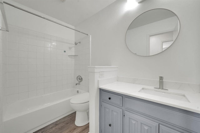 2718 Laurel Oaks Dr, Garland, TX 75044 - bathroom with toilet, wood finished floors, vanity, and shower / bath combination