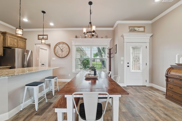 2607 Austin Dr, Granbury, TX 76048 - dining area featuring light wood-type flooring, baseboards, ornamental molding, a chandelier, and recessed lighting