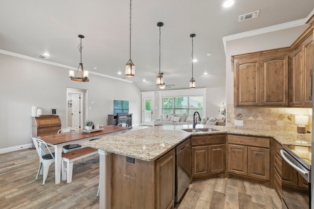 2607 Austin Dr, Granbury, TX 76048 - kitchen with electric stove, a sink, stainless steel dishwasher, a ceiling fan, and light wood-style floors