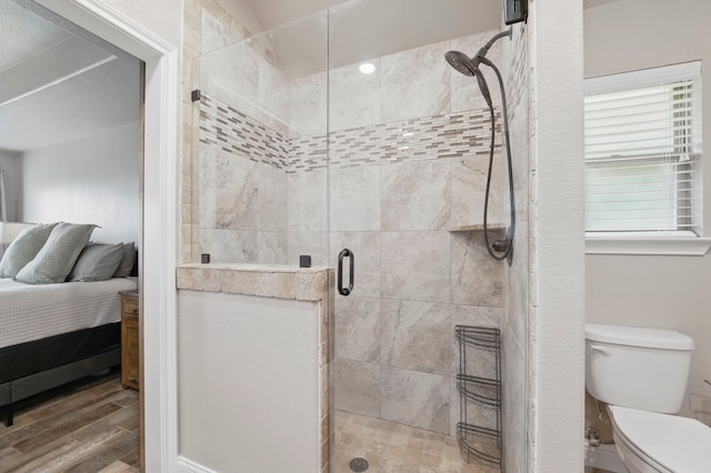 2607 Austin Dr, Granbury, TX 76048 - ensuite bathroom featuring wood finished floors, a shower stall, and toilet