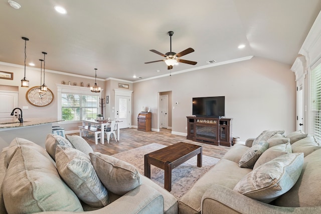 2607 Austin Dr, Granbury, TX 76048 - living room featuring ceiling fan, a chandelier, recessed lighting, baseboards, and ornamental molding