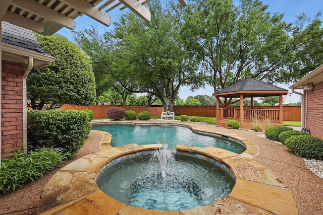 view of pool featuring a gazebo, a fenced backyard, and a pool with connected hot tub