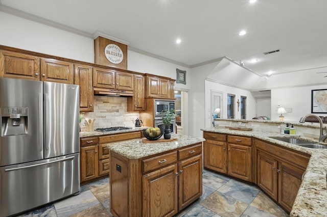 kitchen with stainless steel appliances, a sink, brown cabinetry, decorative backsplash, and crown molding