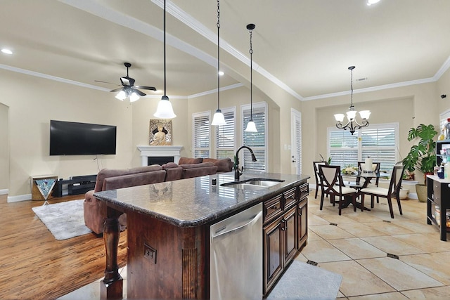 4018 Bear Creek Ct, Celina, TX 75078 - kitchen with a sink, stainless steel dishwasher, a ceiling fan, dark brown cabinetry, and a fireplace