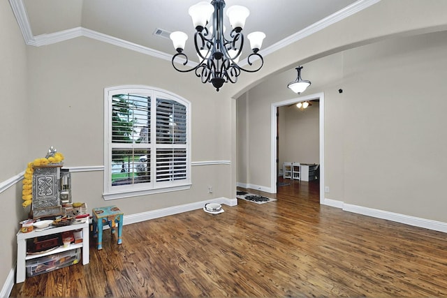 4018 Bear Creek Ct, Celina, TX 75078 - dining room with arched walkways, a chandelier, wood finished floors, ornamental molding, and baseboards
