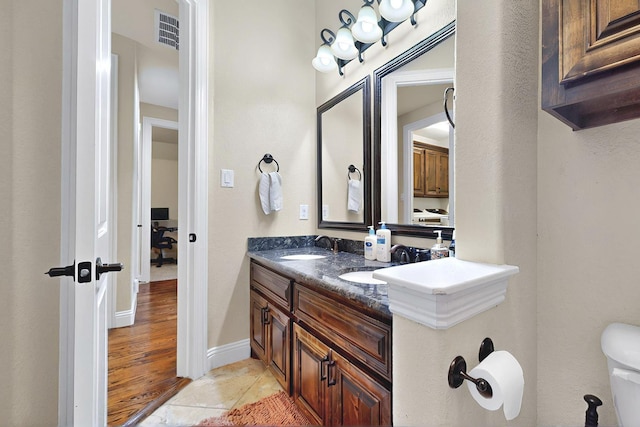 4018 Bear Creek Ct, Celina, TX 75078 - bathroom with double vanity, toilet, and baseboards