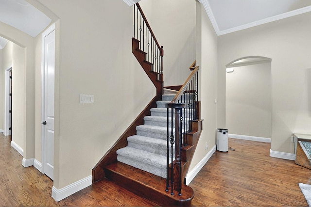 4018 Bear Creek Ct, Celina, TX 75078 - stairway featuring arched walkways, crown molding, wood finished floors, and baseboards