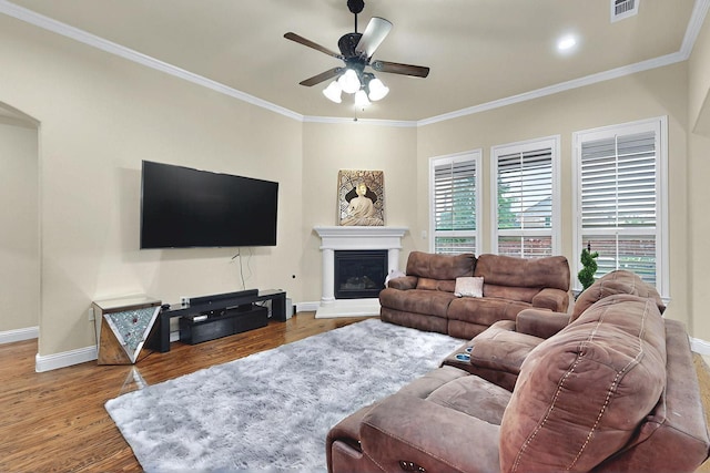 4018 Bear Creek Ct, Celina, TX 75078 - living room featuring ceiling fan, baseboards, wood finished floors, crown molding, and a fireplace with raised hearth