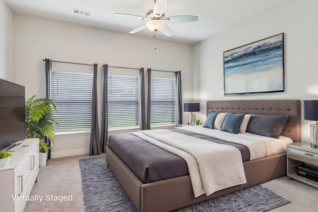 bedroom with light carpet, ceiling fan, and baseboards