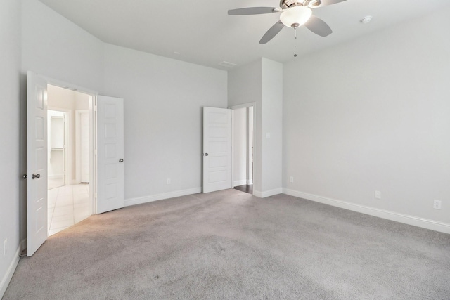 unfurnished bedroom featuring carpet, baseboards, and a ceiling fan