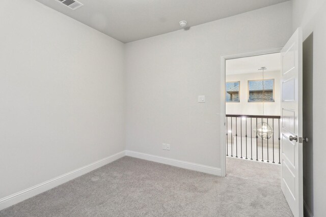 carpeted spare room with baseboards