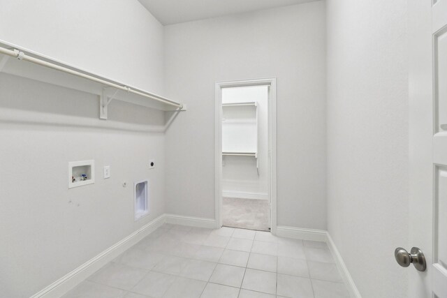 laundry area with electric dryer hookup, washer hookup, hookup for a gas dryer, baseboards, and light tile patterned floors