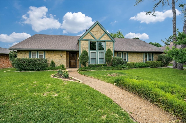 2715 Peach Tree Dr, Carrollton, TX 75006 - view of front of house with brick siding, a front yard, and roof with shingles