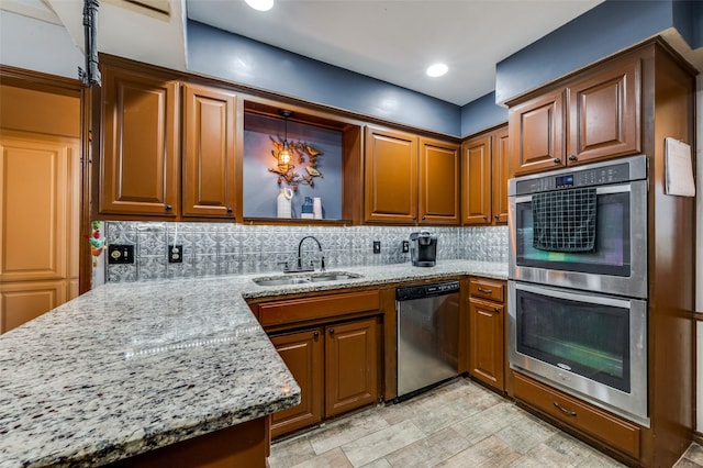 2715 Peach Tree Dr, Carrollton, TX 75006 - kitchen with appliances with stainless steel finishes, a sink, light stone countertops, tasteful backsplash, and brown cabinets