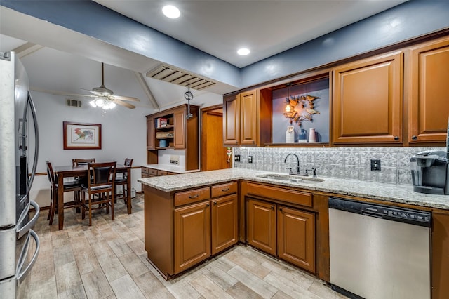 2715 Peach Tree Dr, Carrollton, TX 75006 - kitchen featuring appliances with stainless steel finishes, a sink, open shelves, brown cabinets, and vaulted ceiling