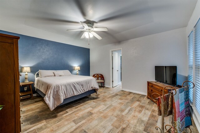 2715 Peach Tree Dr, Carrollton, TX 75006 - bedroom with light wood-style flooring, a ceiling fan, and baseboards