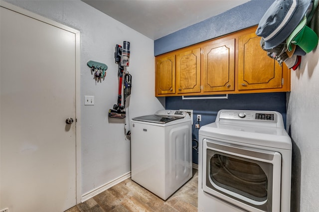 2715 Peach Tree Dr, Carrollton, TX 75006 - laundry room featuring separate washer and dryer, cabinet space, light wood-style floors, and baseboards