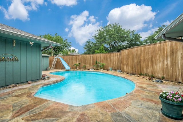 2715 Peach Tree Dr, Carrollton, TX 75006 - view of swimming pool with a water slide, a fenced backyard, and a patio area