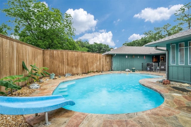 2715 Peach Tree Dr, Carrollton, TX 75006 - view of pool with a water slide and a fenced backyard