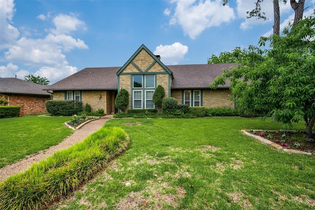 2715 Peach Tree Dr, Carrollton, TX 75006 - view of front of home featuring brick siding, a front lawn, and roof with shingles