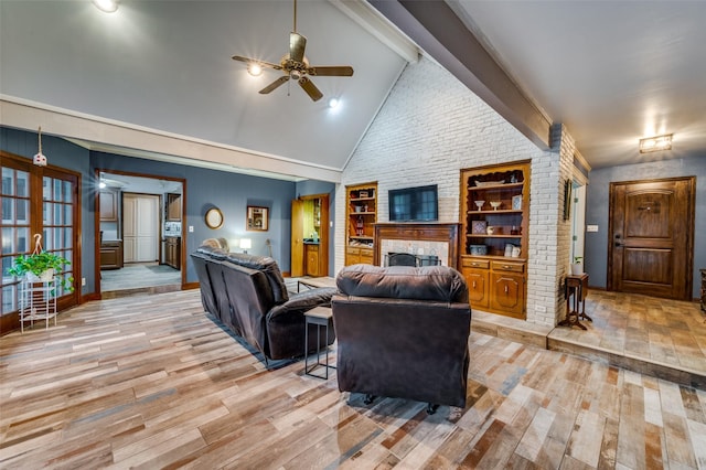 2715 Peach Tree Dr, Carrollton, TX 75006 - living area featuring wood finished floors, ceiling fan, a large fireplace, built in shelves, and baseboards