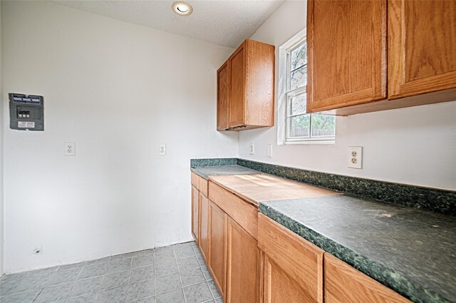 kitchen with dark countertops and brown cabinetry