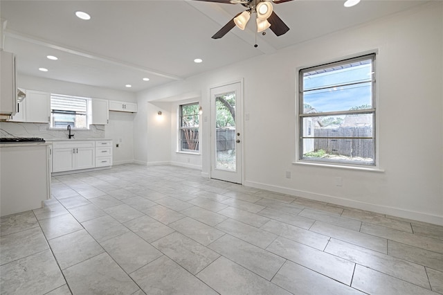 unfurnished living room with a ceiling fan, recessed lighting, baseboards, and light tile patterned floors