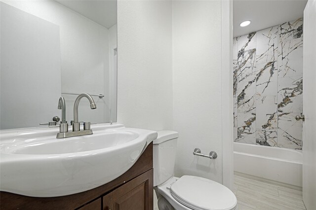 bathroom featuring toilet, vanity, bathing tub / shower combination, and recessed lighting