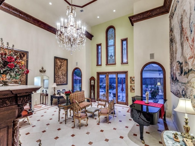 lobby featuring a towering ceiling, recessed lighting, and crown molding