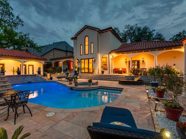 swimming pool with an in-ground hot tub and a patio area
