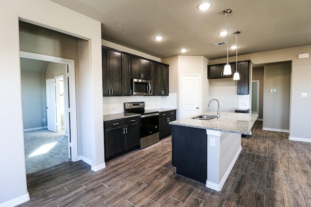 504 Lakeway Ln, Justin, TX 76247 - kitchen featuring stainless steel appliances, a sink, wood finish floors, baseboards, and recessed lighting