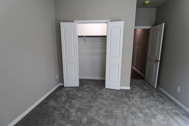 504 Lakeway Ln, Justin, TX 76247 - unfurnished bedroom featuring dark carpet, a closet, and baseboards
