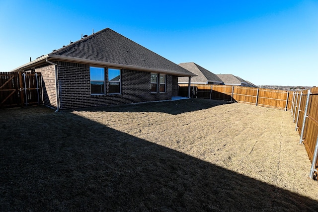 504 Lakeway Ln, Justin, TX 76247 - back of house featuring brick siding and roof with shingles