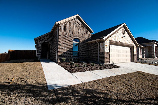 504 Lakeway Ln, Justin, TX 76247 - french provincial home with a garage, fence, brick siding, and concrete driveway